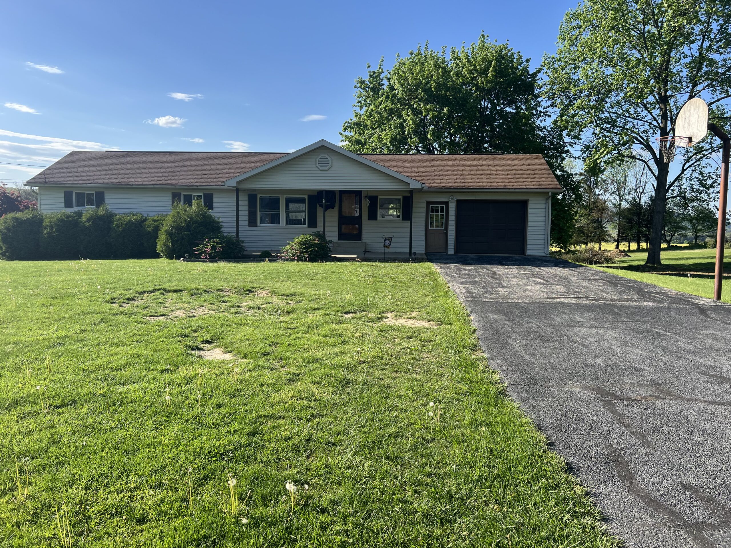 Long ranch house with an attached garage and wide front lawn in Williamston